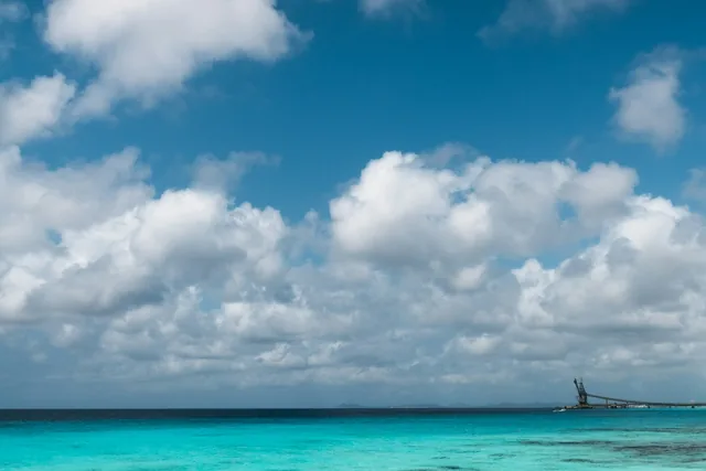 Clear sea along the coast of Bonaire with Salt Pier in the distance