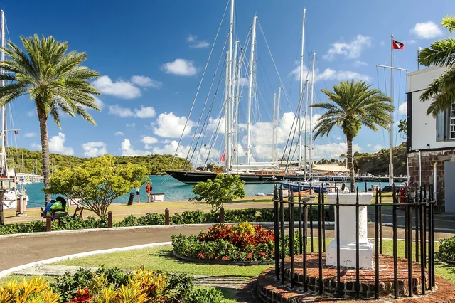 Palm trees and sailboats at Nelson’s Dockyard in English Harbour, Antigua.