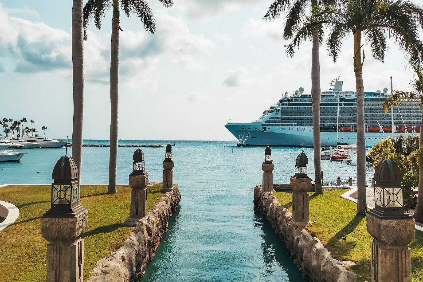 Palm trees beside a cruise ship in the harbour of Oranjestad, Aruba