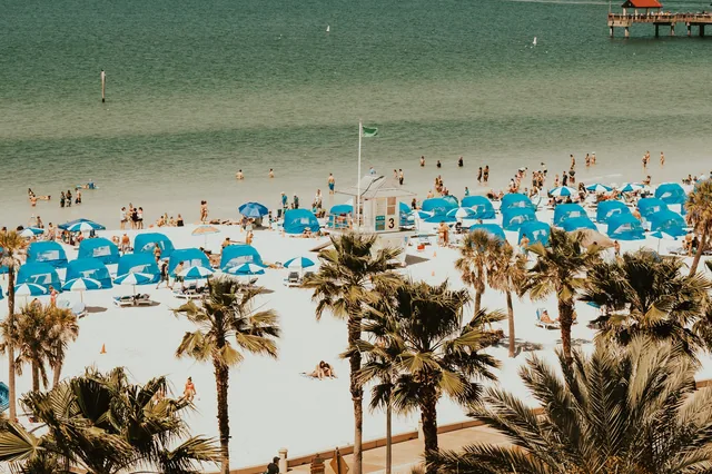 Beachgoers and parasols at Baha Mar in Nassau, Bahamas.