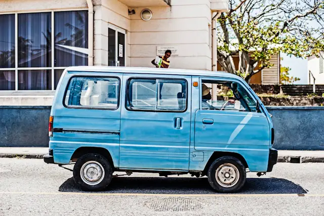 A blue vehicle parked along a street in Barbados