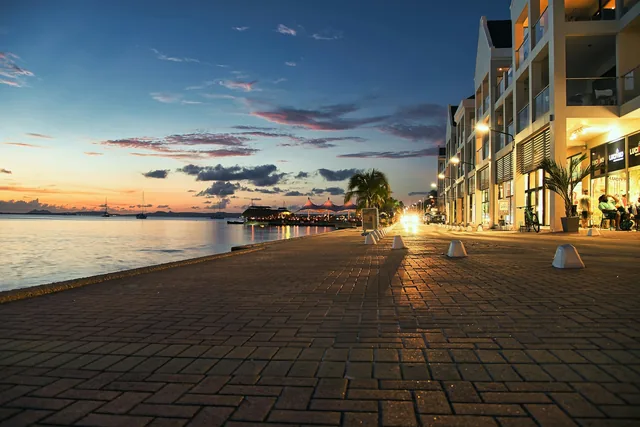 Tables and buildings along the waterfront on Bonaire in the evening