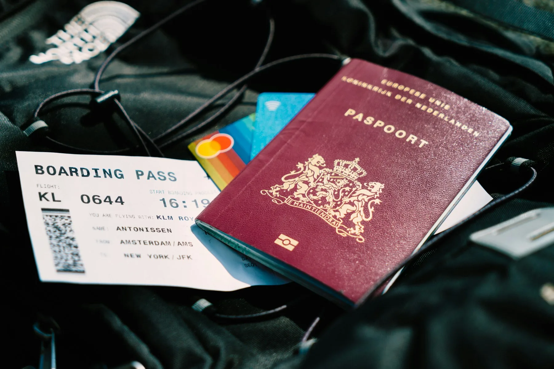 A passport and boarding pass on a travel bag