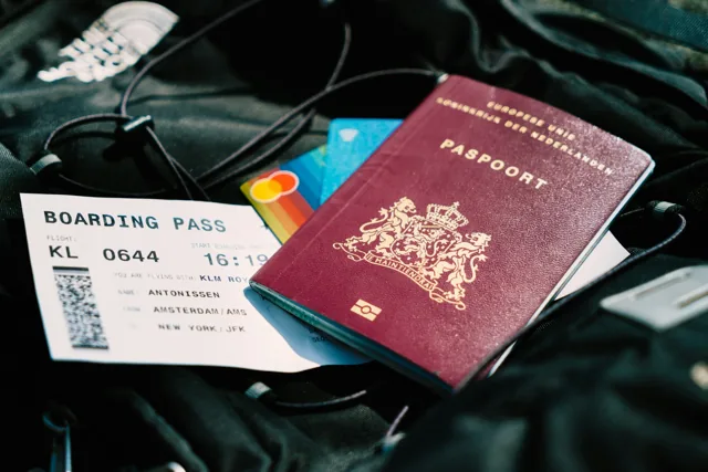 A passport and boarding pass on a travel bag