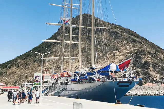 A sailing yacht moored below a hillside in St. Maarten